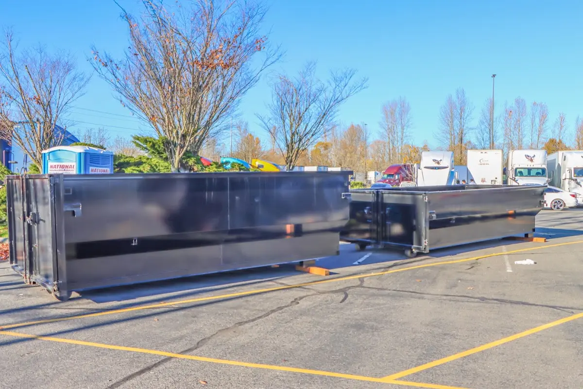 Professional dumpster rental service with roll-off container on residential driveway in Fairfield Plantation